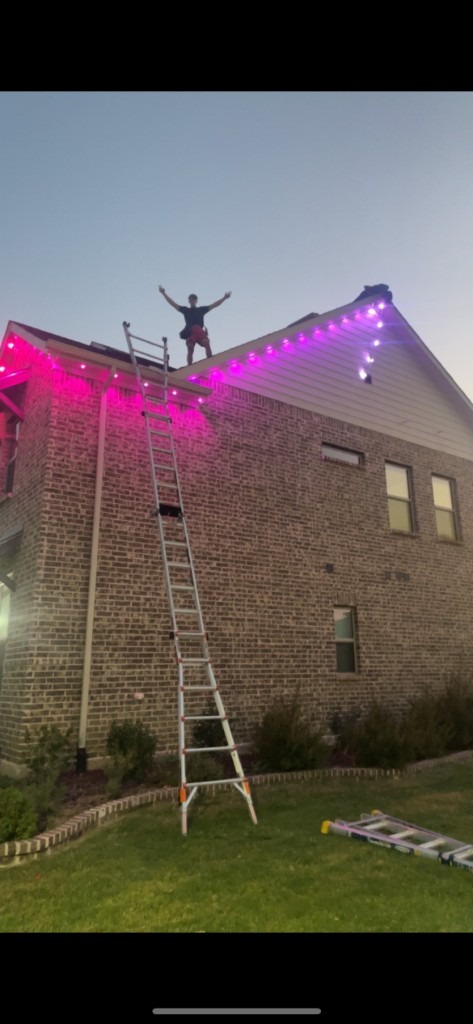 Install day with pink roofline lights and ladder work