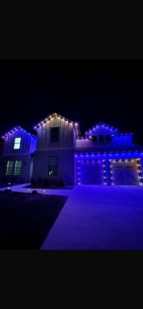 Purple LED lighting on peaks, eaves, and garage doors
