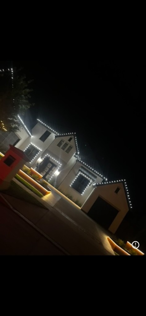 Red and white roofline lights with wrapped porch pillars