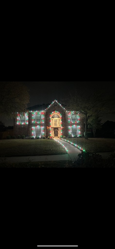 Warm white roofline with lit walkway and tree wraps