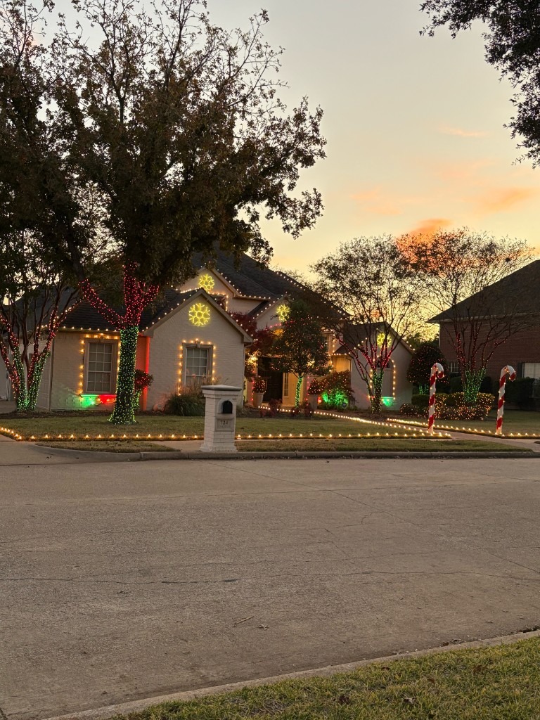 Warm white peak and window lights on a brick house
