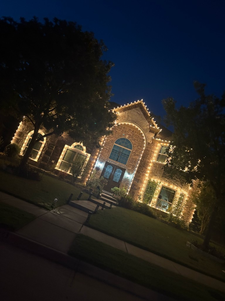 Warm white peak and window outlining on a brick home