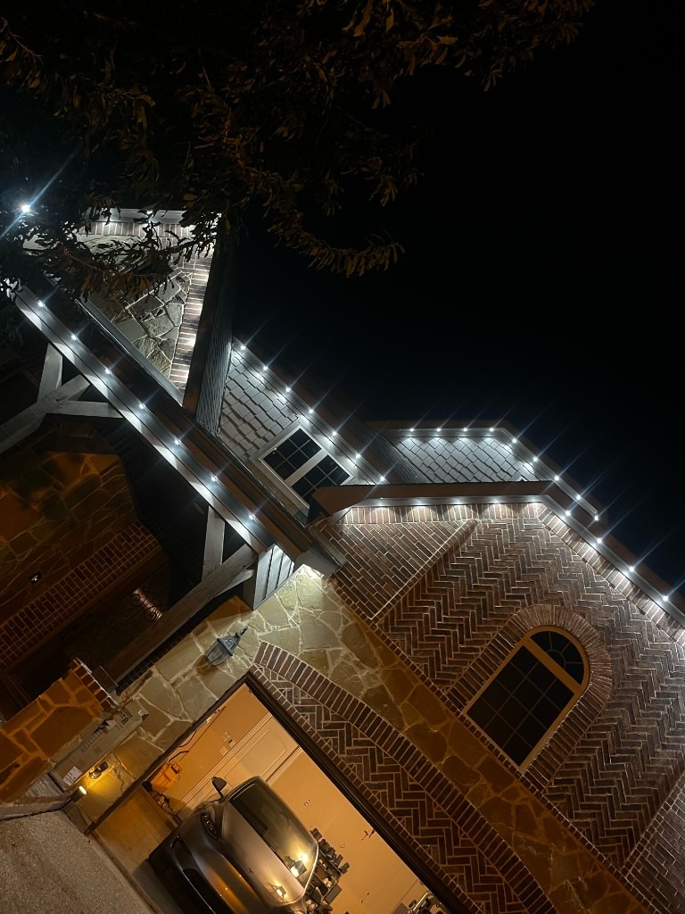 Cool white LED eaves lighting on stone and brick